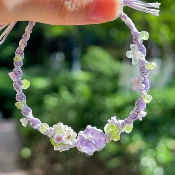 Hand woven bracelet with purple fluorite crystal and fairy like flowers, playful and sweet bracelet