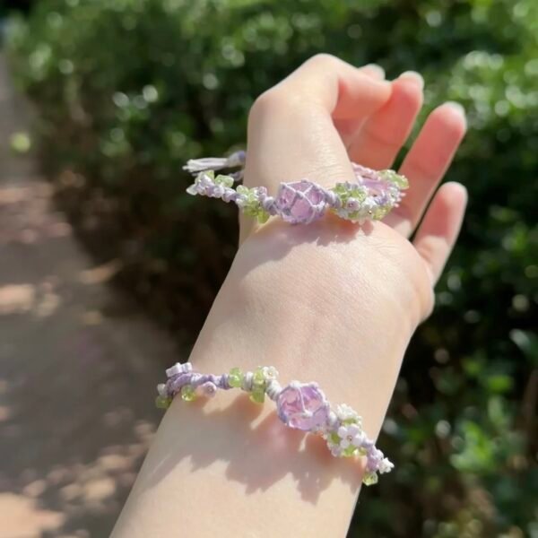 Hand woven bracelet with purple fluorite crystal and fairy like flowers, playful and sweet bracelet
