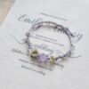 Hand woven bracelet with purple fluorite crystal and fairy like flowers, playful and sweet bracelet