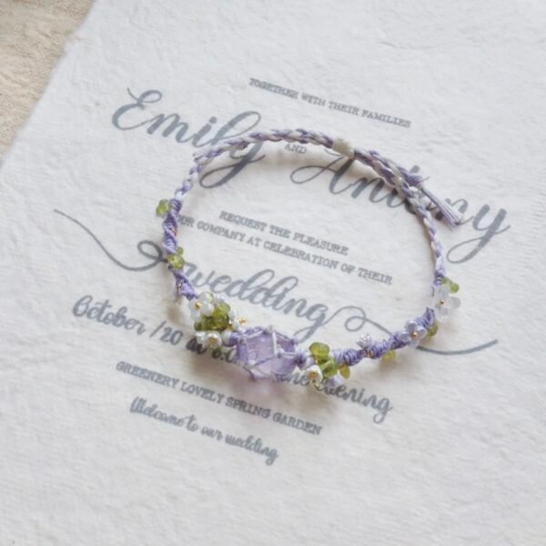 Hand woven bracelet with purple fluorite crystal and fairy like flowers, playful and sweet bracelet