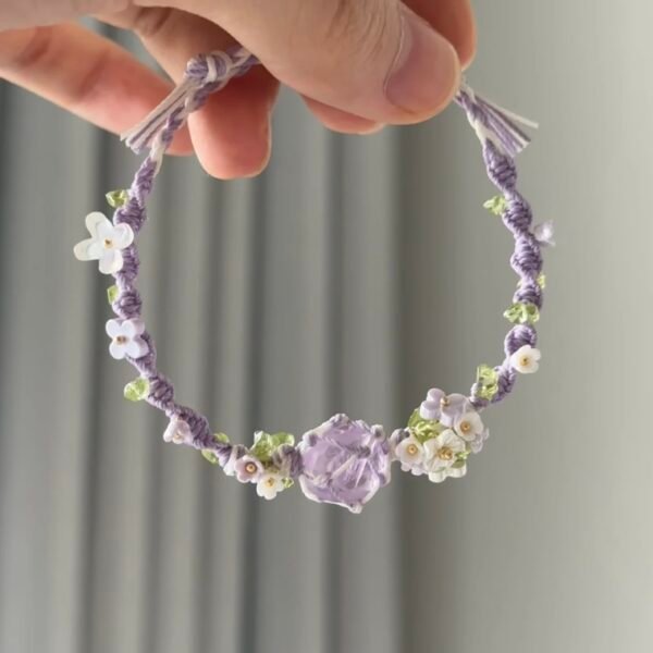 Hand woven bracelet with purple fluorite crystal and fairy like flowers, playful and sweet bracelet